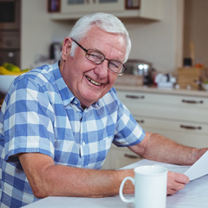 A man smiles as he reads